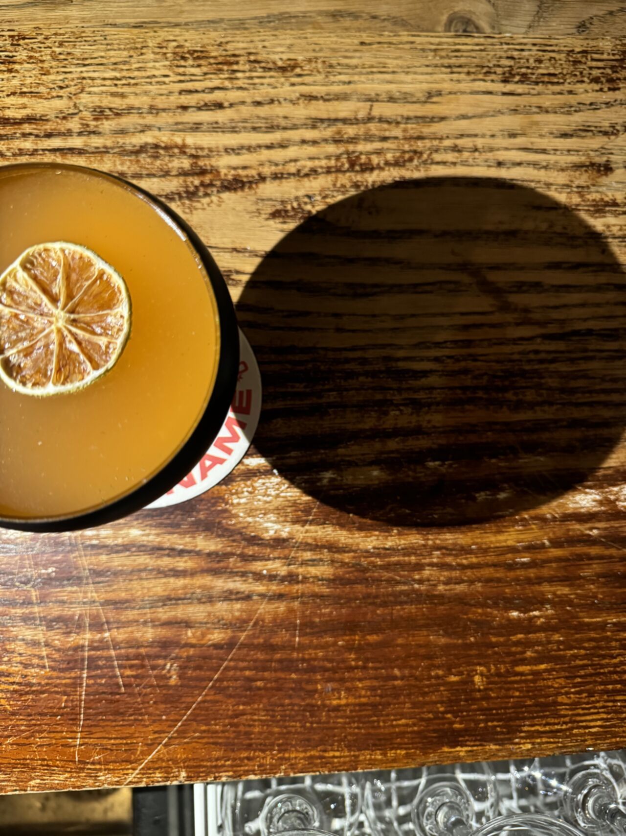 Cocktail mit getrockneter Limette auf dem Tresen, von oben fotografiert